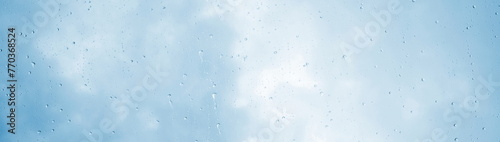 Raindrops, water dripping, rain on a glass pane, rainy weather with clouds photo