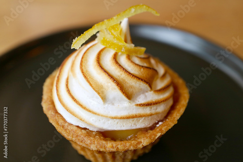 Tasty Sweet and Sour Lemon Meringue Tart on Black Plate