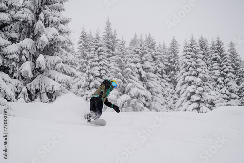 Snowboarder riding fast on snow freeride slope photo