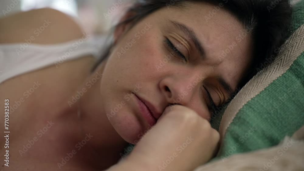 Tired woman close-up face overwhelmed by fatigue laid down on couch, close-up face of 30s female person feeling stress and mental struggle Tired woman close-up face overwhelmed by fatigue laid down on couch, close-up face of 30s female person feeling stress and mental struggle