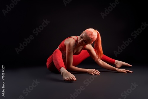 Athlete woman stretching on the floor with her legs apart