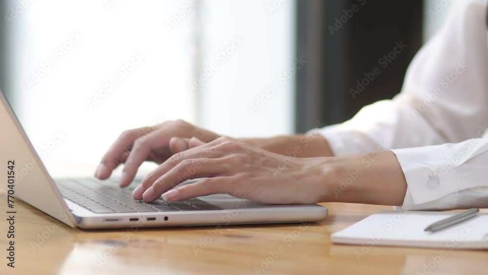 close up of a person typing on a laptop computer. close up of a person typing on a laptop computer.