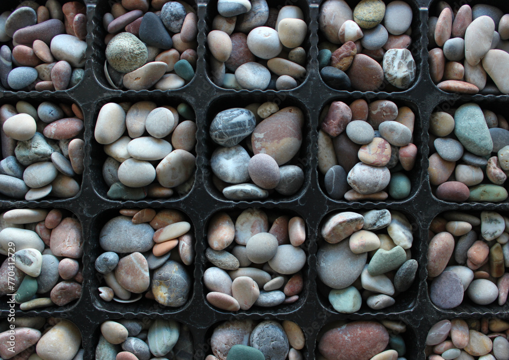 Symmetrical Pattern Of Plastic Tray With Same Cells Filled With Round River Rocks Symmetrical Pattern Of Plastic Tray With Same Cells Filled With Round River Rocks
