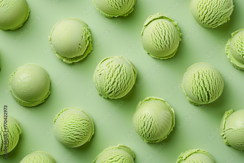 A pattern of scooped avocado ice cream , top view on pastel green background
