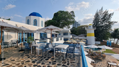 Fotografie Relaxing outdoor dining area with shaded tables and colorful umbrellas set again