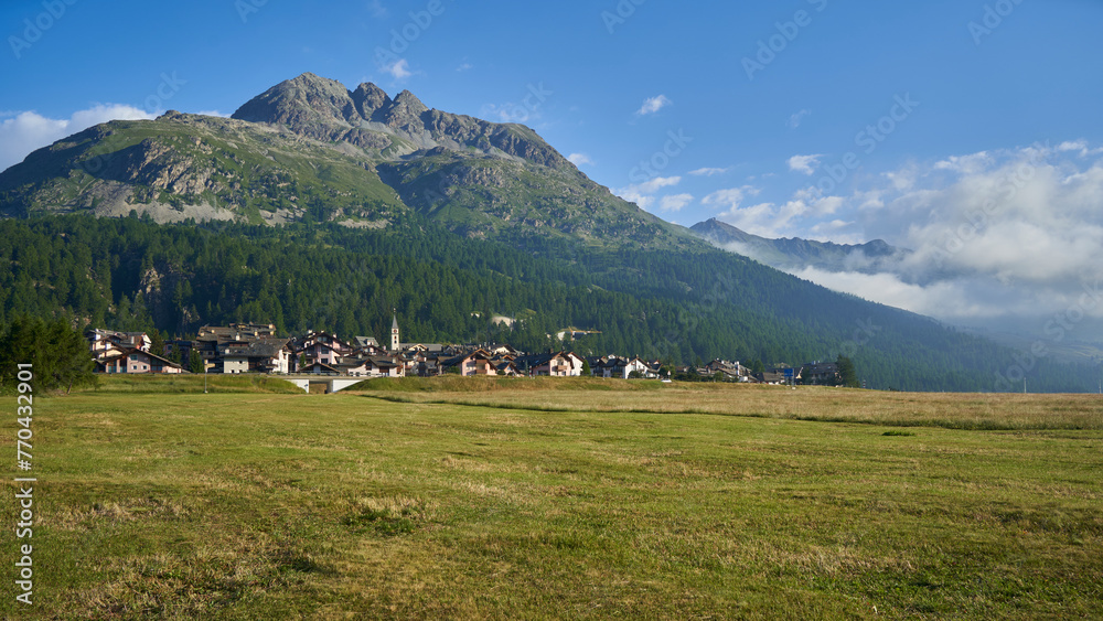 Village in Switzerland in front of a mountain. Landscape in summer with blue sky. Swiss, Silvaplana, Engadin.