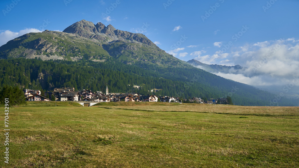 Village in Switzerland in front of a mountain. Landscape in summer with blue sky. Swiss, Silvaplana, Engadin. Village in Switzerland in front of a mountain. Landscape in summer with blue sky. Swiss, Silvaplana, Engadin.