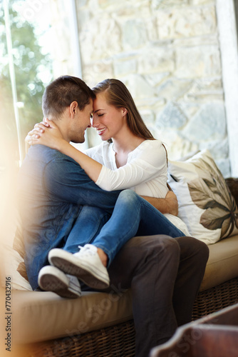 Home, couple and forehead for love, embrace and romance or care on couch in living room. Happy people, touch and smile for pride in relationship or commitment, loyalty and connection on hug date