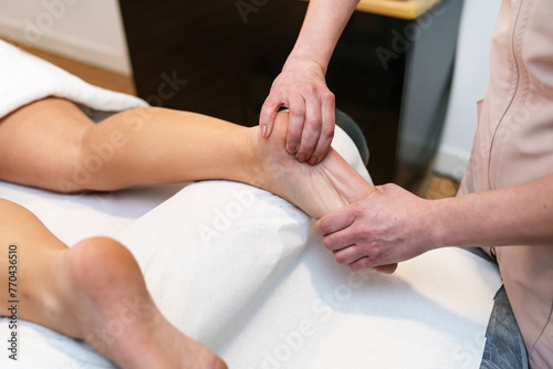 A close-up of a stretching massage on a foot.