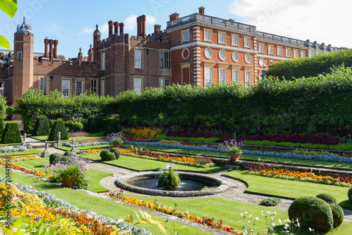 Georgian and Tudor facades and sunken gardens of Hampton Court Palace in East Molesey