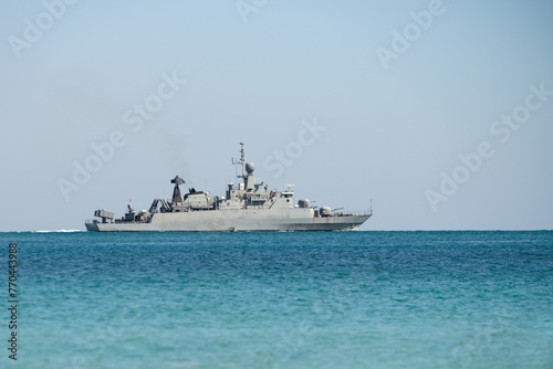 Frigate of Royal Thai Navy sails along sea blue sky no people