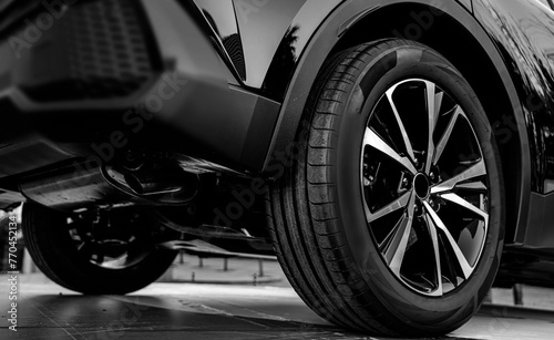 black Car in showroom. Aluminum wheel with Tire. automobile wheel tire. aluminium rims. Motor Corporation is Japanese automotive manufacturer. 4х4. 4wd.