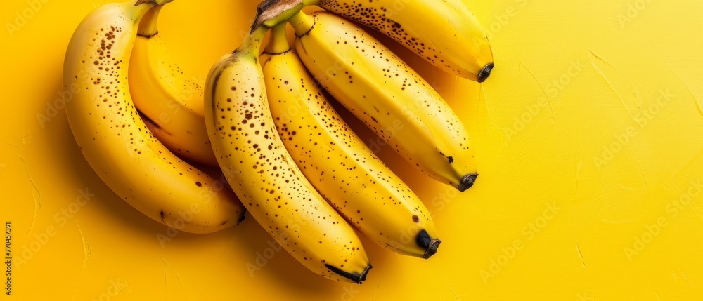   A collection of overripe bananas arranged atop two identical yellow tables