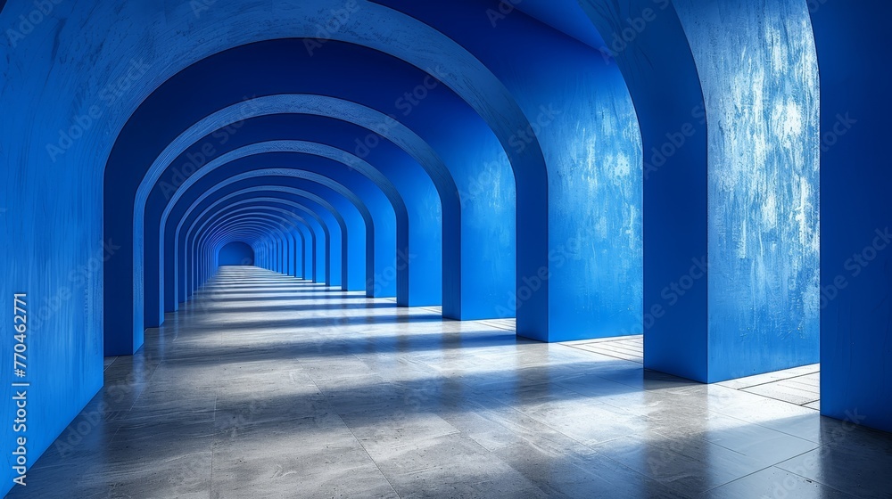 Long hallway, blue walls, tiled floor, arches on either side Long hallway, blue walls, tiled floor, arches on either side