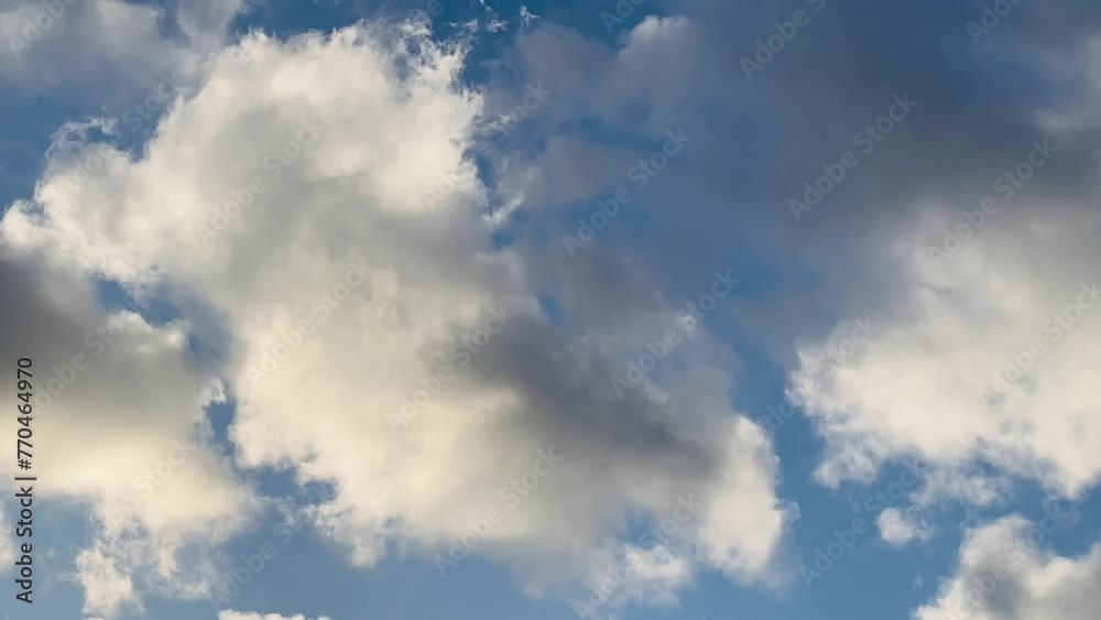 Expansive blue sky adorned with soft, fluffy clouds, capturing the essence of tranquillity in the English Countryside Expansive blue sky adorned with soft, fluffy clouds, capturing the essence of tranquillity in the English Countryside