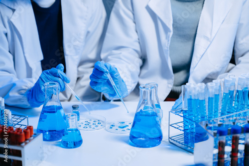 Obraz na plátně Two Scientist mixing chemical liquids in the chemistry lab