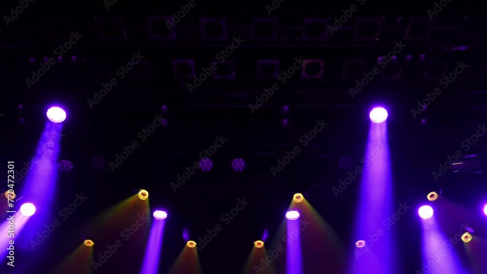 musical concert stage purple and white lightning lights the stage, working spotlights