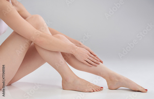 Woman, leg or hand in epilation, skincare or cosmetology as luxury, wellness or self care in studio. Female person, touch or smooth skin in satisfaction of hair removal, dermatology or hygiene result © peopleimages.com