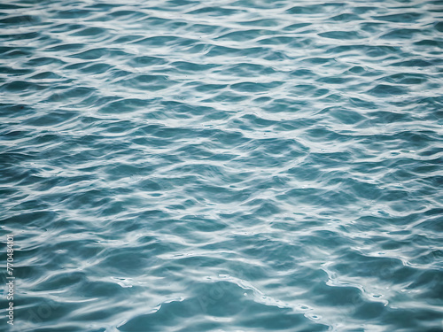 Blue water surface texture background. Close up of rippled water surface. © wannasak