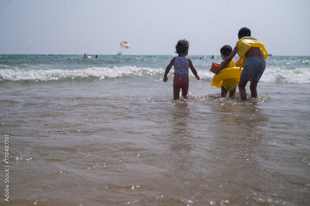 Child stands at seaside representing family resorts beach vacations