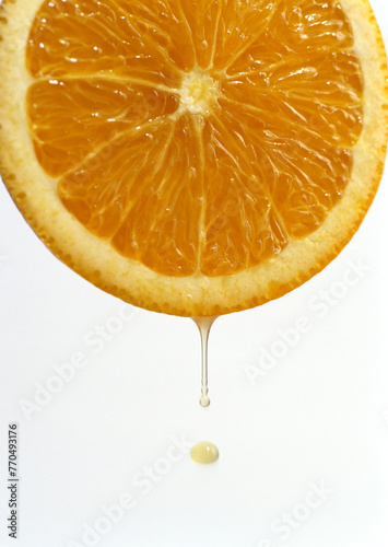 Slice of fresh orange with juice drop