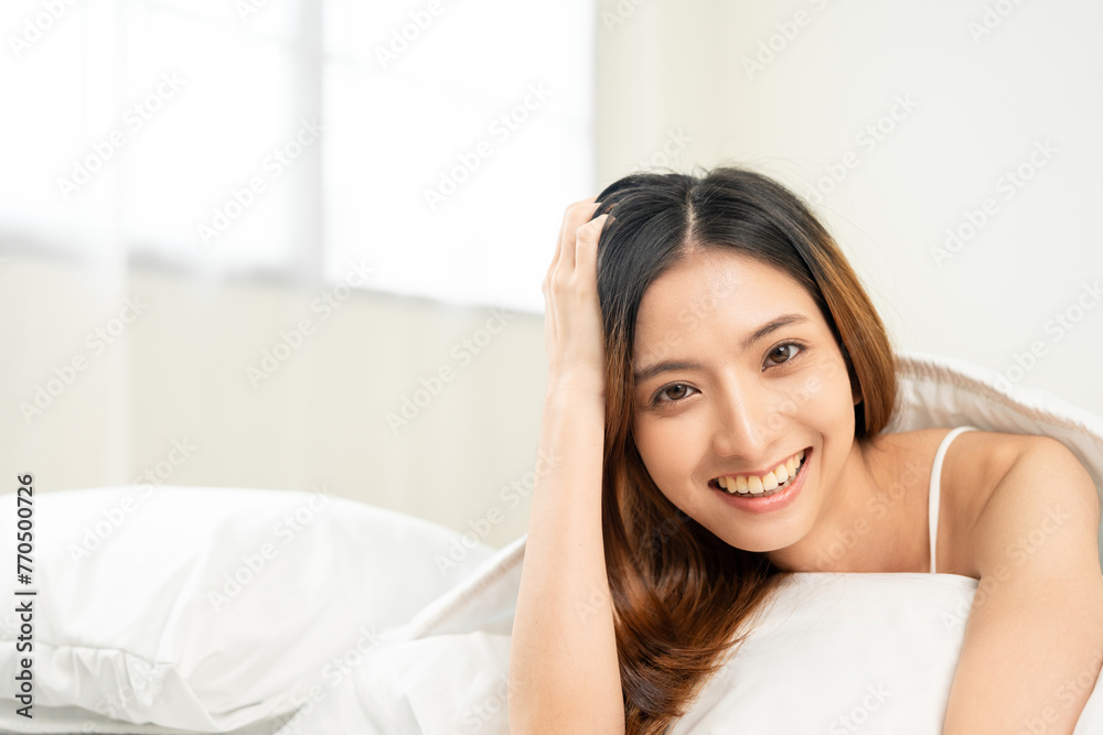 Young woman wake up before lying asleep enjoying healthy in the morning. Beautiful asian woman sleeping well in comfortable cozy fresh bed on soft pillow white linen. Young woman wake up before lying asleep enjoying healthy in the morning. Beautiful asian woman sleeping well in comfortable cozy fresh bed on soft pillow white linen.