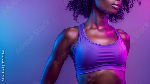 Afro american fitness woman in purple top with well defined abdominal muscles photo