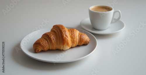 A croissant and coffee cup, morning breakfast