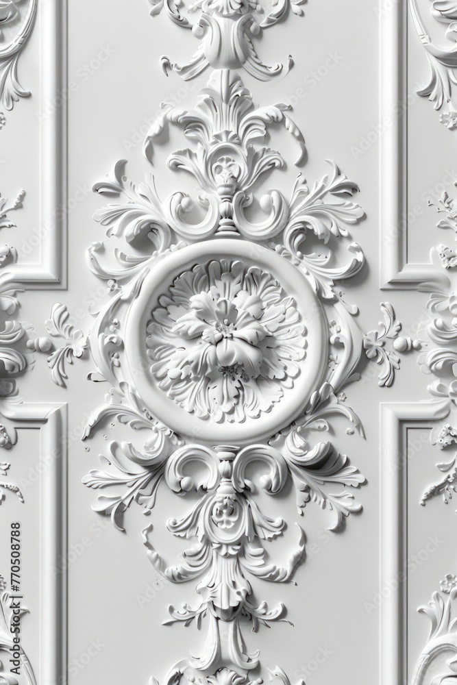 White ornamental plasterwork with floral and swirl elements.