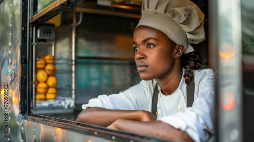 Fototapeta Naklejka Na Ścianę i Meble -  Focused female chef in food truck.