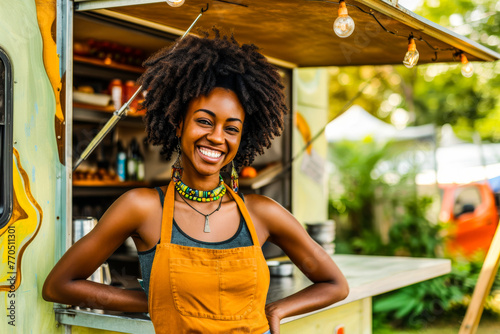 A young, joyful female food truck worker in an apron represents friendly customer service and entrepreneurship photo
