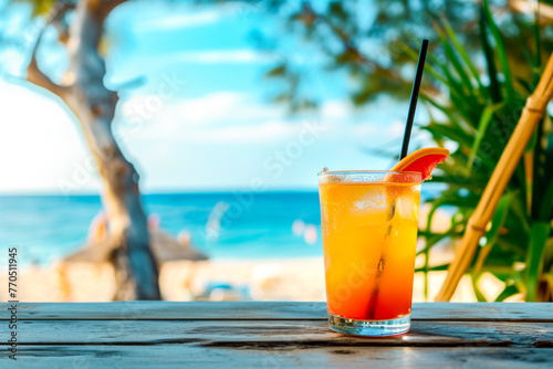 A vibrant orange cocktail stands against the backdrop of a tranquil beach and azure waters, an embodiment of leisure