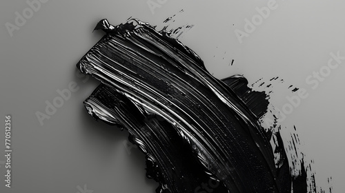 An artistic depiction of a bold, textured black brush stroke against a smooth gray gradient background, conveying movement and emotion