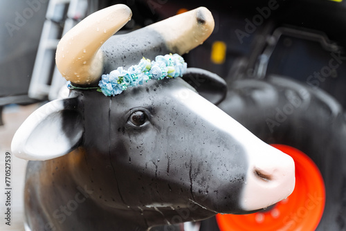 A white cow adorned with a flower crown, a stunning work of art at the event photo