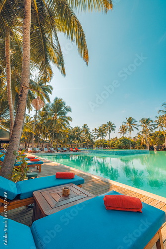 Happy tourism holiday landscape. Luxury beach resort hotel swimming pool, leisure beach chairs under umbrellas palm trees, blue sunny sky. Summer island seaside, relax mood travel vacation background © icemanphotos