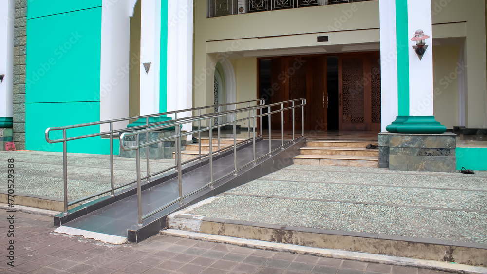 Main Ramp Wheelchair ramp with stainless steel handrail at the main entrance of a ...