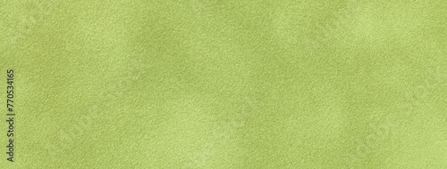 Texture of light green velvet matte background, macro. Suede olive fabric with pattern.