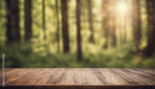 An empty wooden table set against a blurred backdrop of a sunlit forest, ideal for showcasing products in a tranquil, natural ambiance. photo