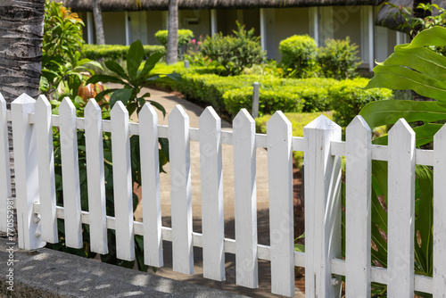 White wooden fence in the garden. Selective focus and small depth of field. photo