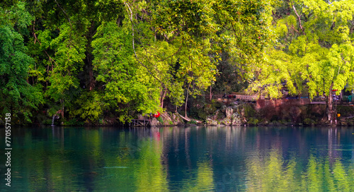 Beautiful view of the blue lake surrounded by trees around it.