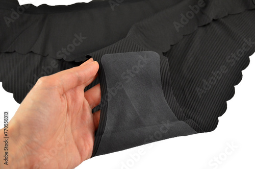 Gusset, black seamless (invisible) women's underwear (lingerie, panties, briefs) with wavy edge isolated, inner part closeup