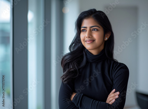 Indian woman with crossed arms wearing a formal shirt	