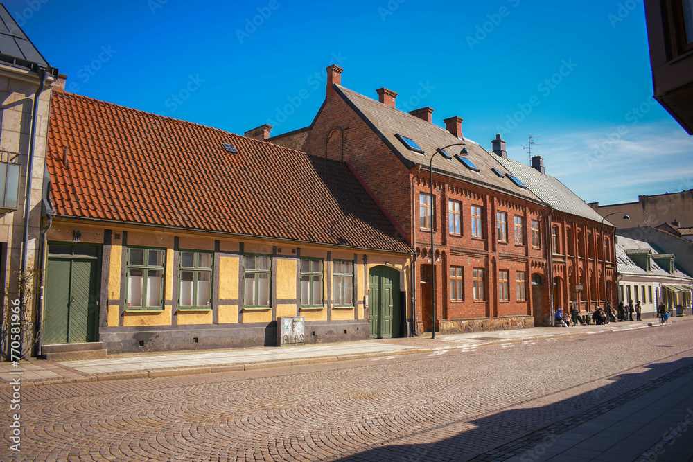 Building facades in the old town of Lund, Scandinavian architecture. Old buildings near the campus grounds of Lund university in Sweden. Cobblestone street.
