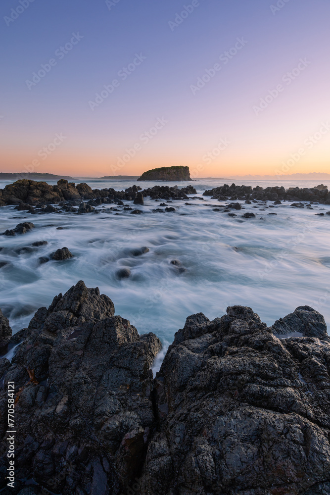 Morning view of Stack Island from the rocky coastline of Minnamurra, Australia.