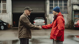 Friendly Handshake between Two Men Outdoors. Two men in casual attire exchanging a warm handshake in an outdoor setting, possibly concluding a friendly agreement or greeting.