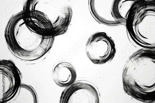 Abstract monochrome background with black paintbrush enso circles, round strokes pattern on white photo