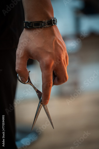 Scissors for haircuts in a barbershop hand