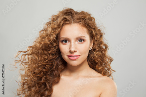 Gorgeous woman face. Young model with healthy skin, long hair and makeup on white background