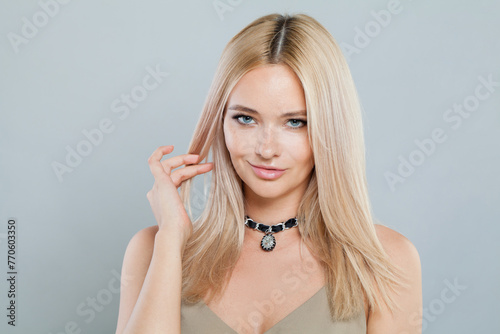 Healthy blonde person portrait. Beauty woman with clear shiny fresh skin and blond hair on white background. Skincare, cosmetology and fashion concept