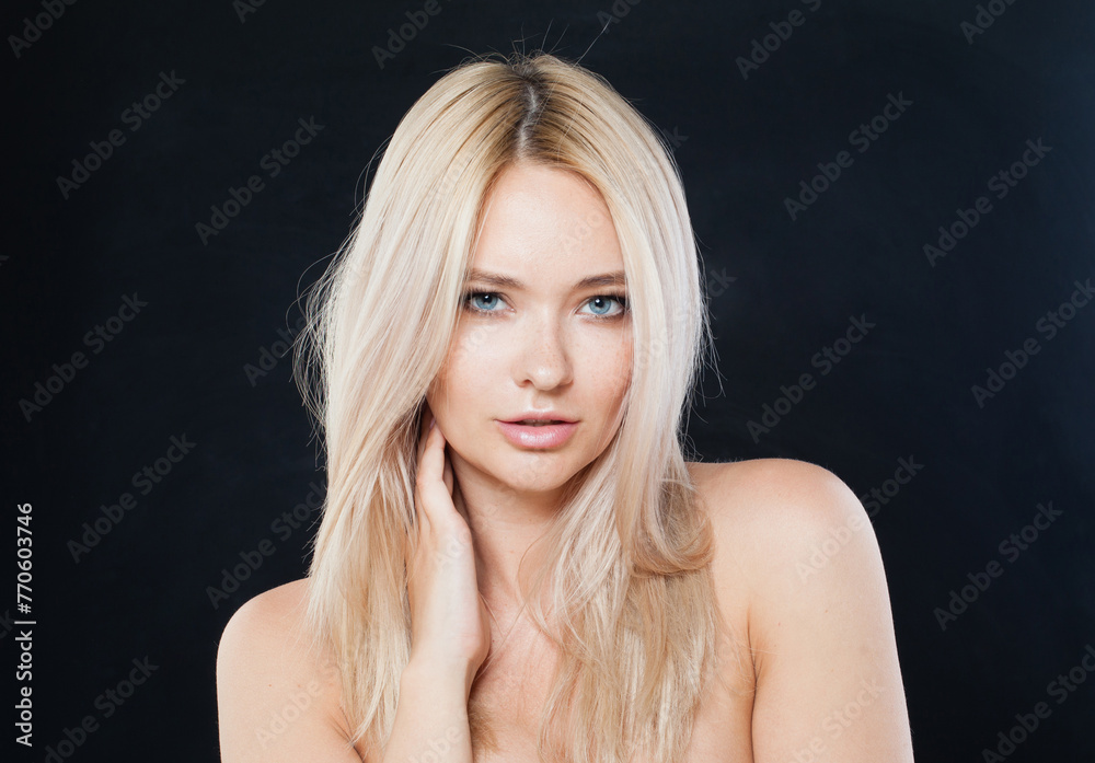 Posing woman face close-up. Blonde model with fresh clear skin and healthy silky hair on black background - obrazy, fototapety, plakaty 
